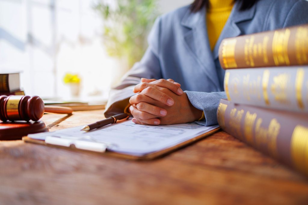 Client and lawyer clasping hands over legal documents